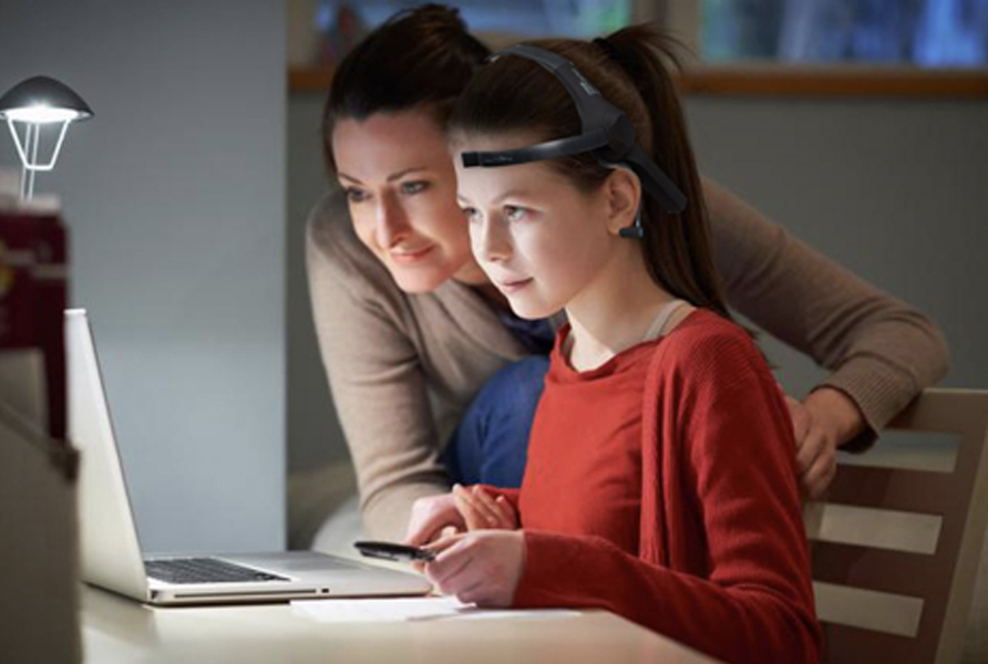 Child studying with parent wearing eeg headset