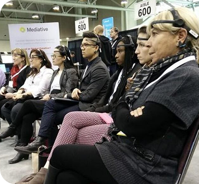 Group of participants wearing EEG headsets during a technology conference demonstration