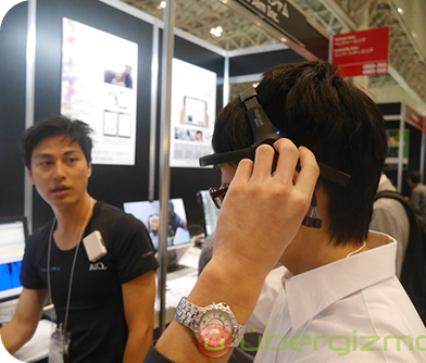 Visitor trying on EEG headset during technology expo demonstration